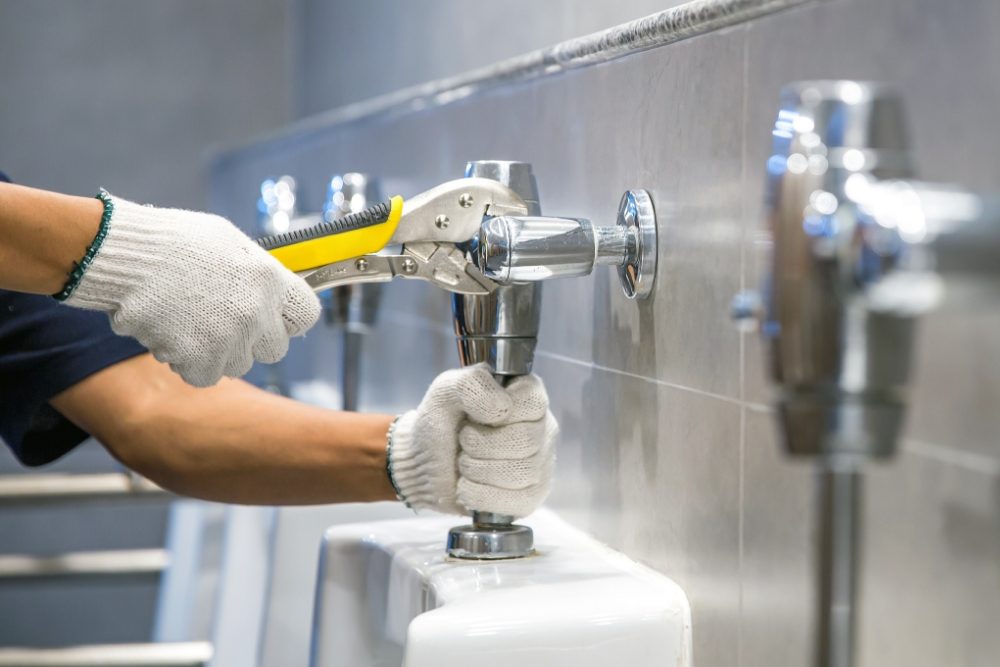 TMG technician performing commercial plumbing service