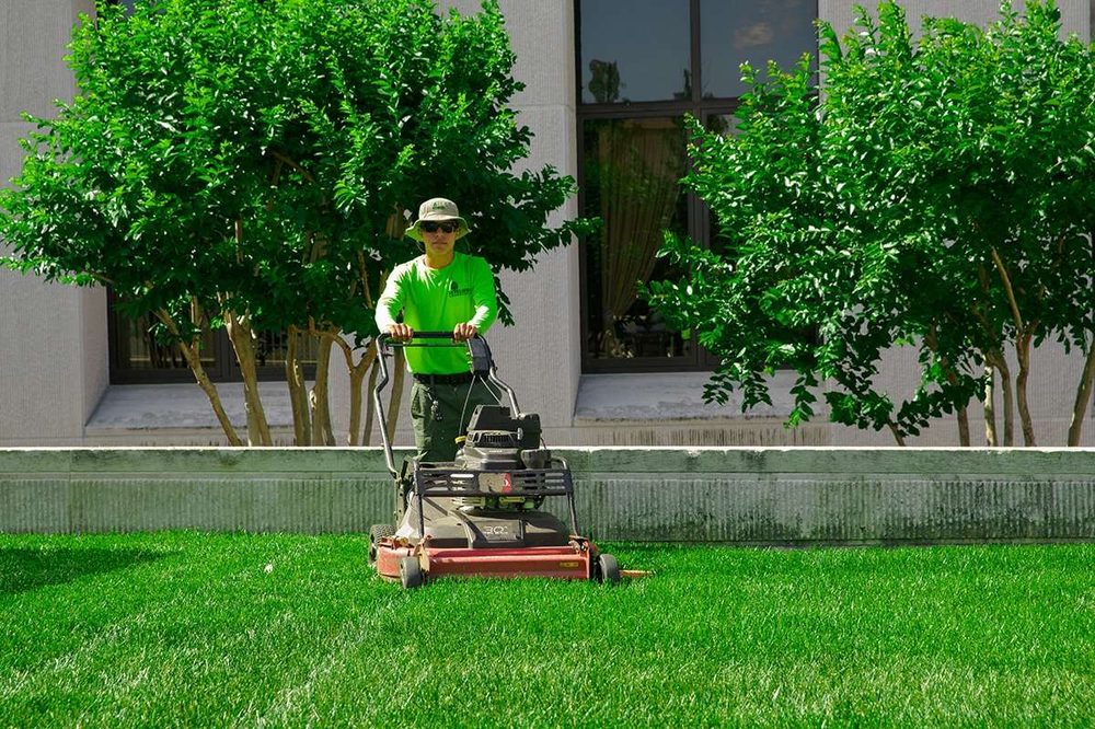 TMG grounds crew mowing a commercial lawn