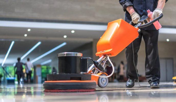 Floor care technician buffing a commercial floor